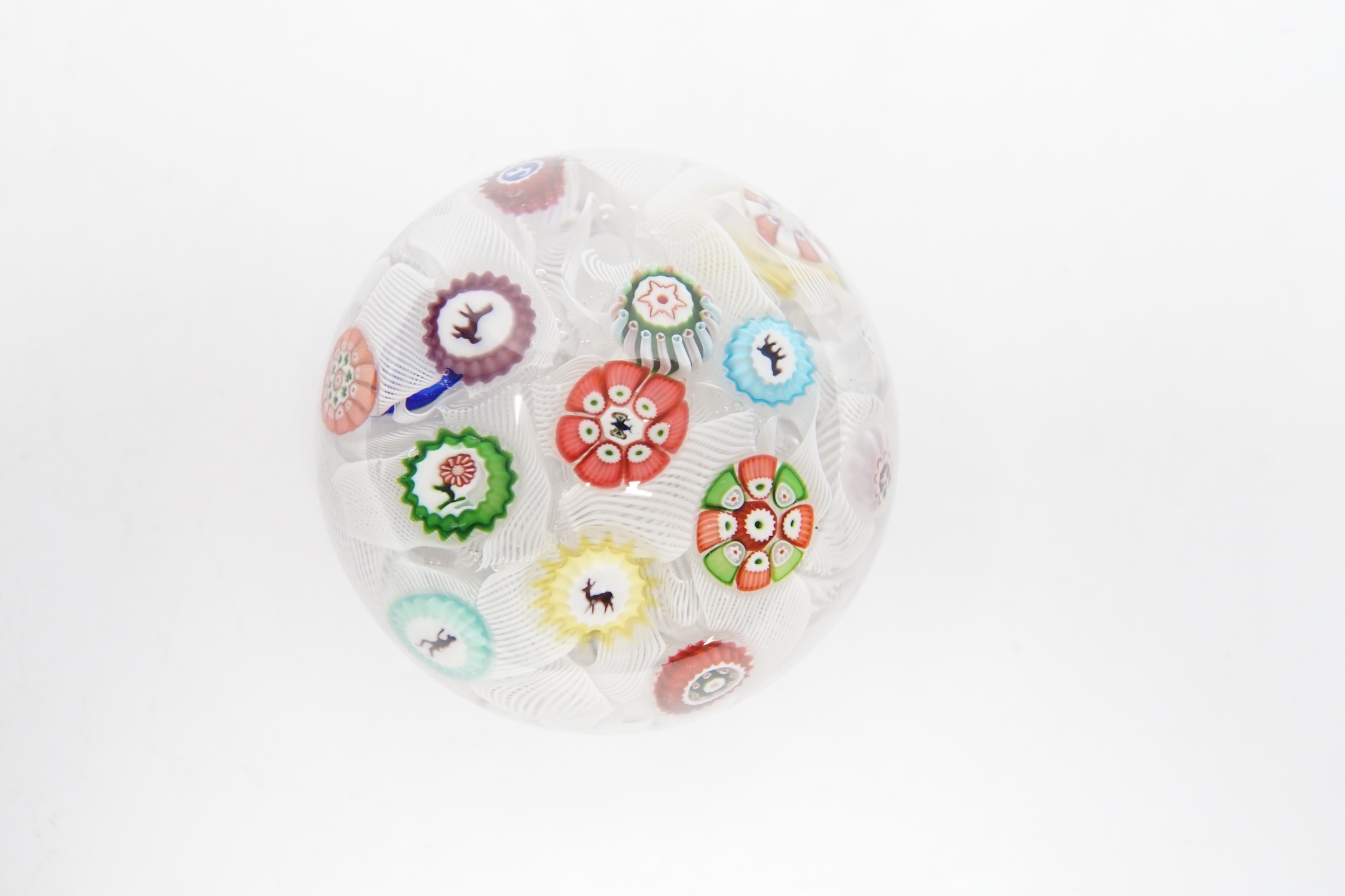 A Baccarat glass paperweight with scattered silhouette and other canes on a quilted latticino ground, dated B1848, 5.2cm